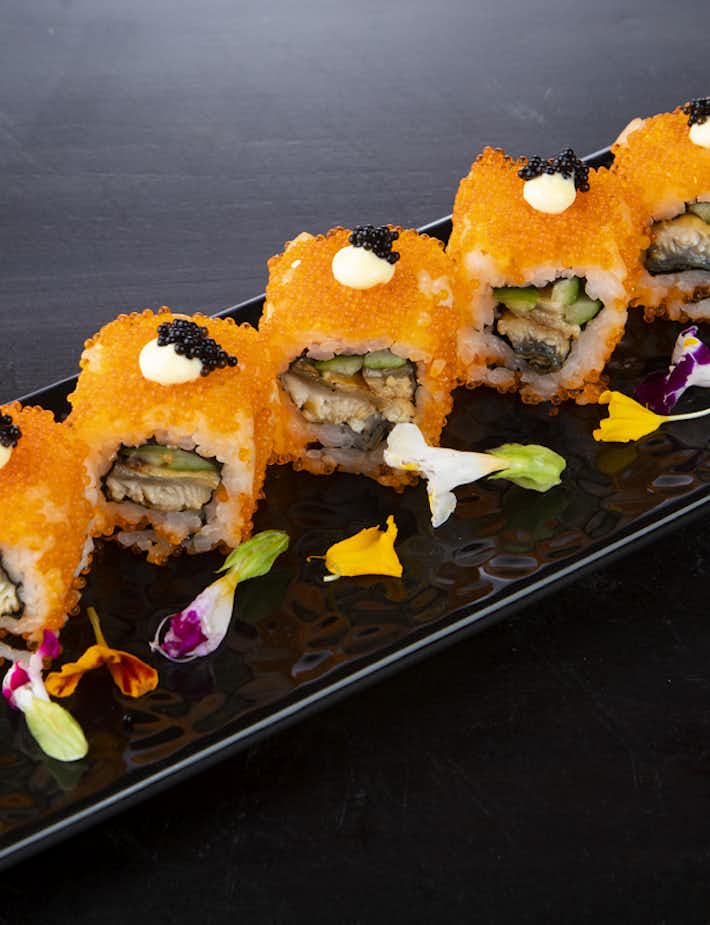 Avacado sushi rolls displayed on a black sushi plate at The Kingsbury Hotel