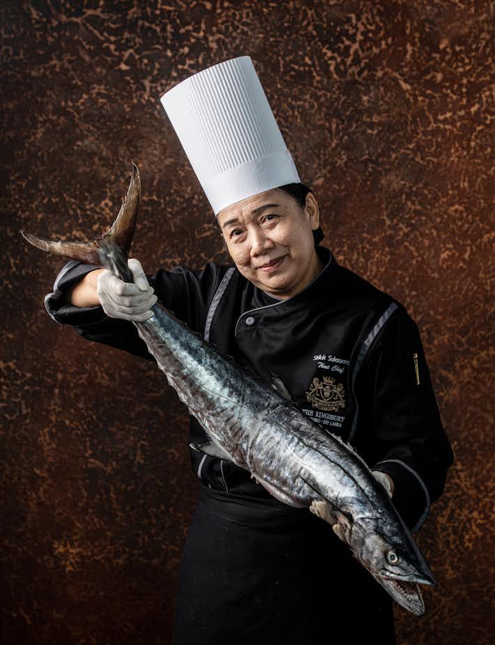 Chef holding a large fish with both hands at The Kingsbury Hotel
