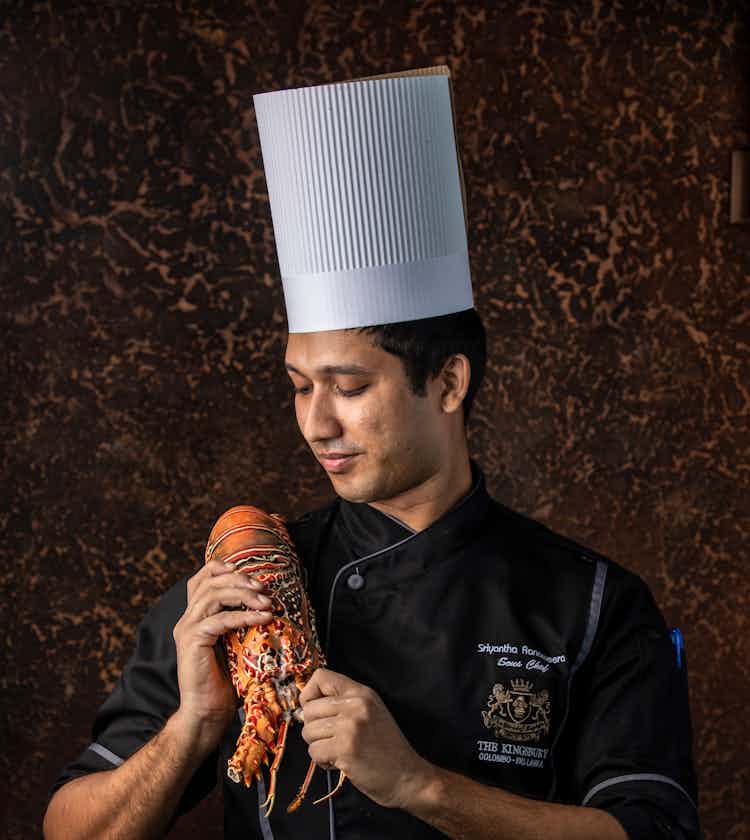 Chef holding a losbster at The Kingsbury Hotel