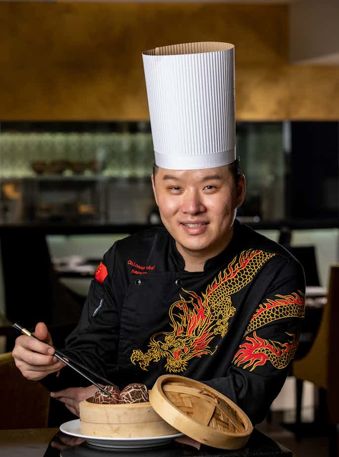 Chef at Yue Chuan Chinese restaurant with dumplings 