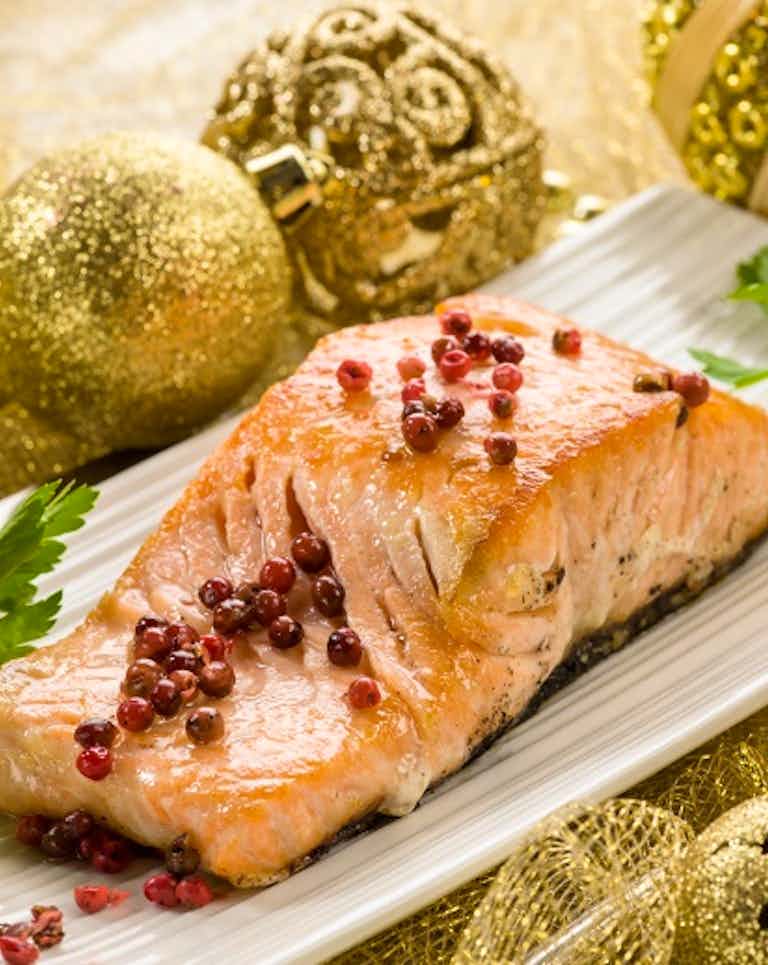 Roasted salmon fish displayed with Chrismas ornaments 
